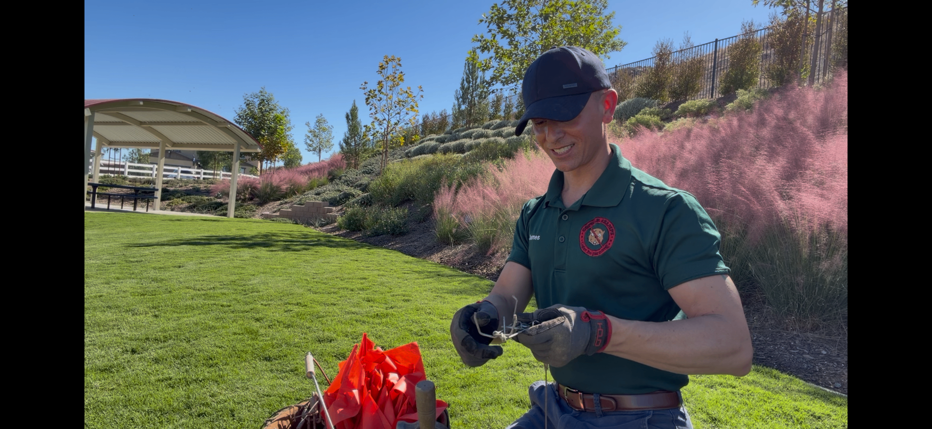 James, Gopher Champs technician, setting gopher traps on a lawn