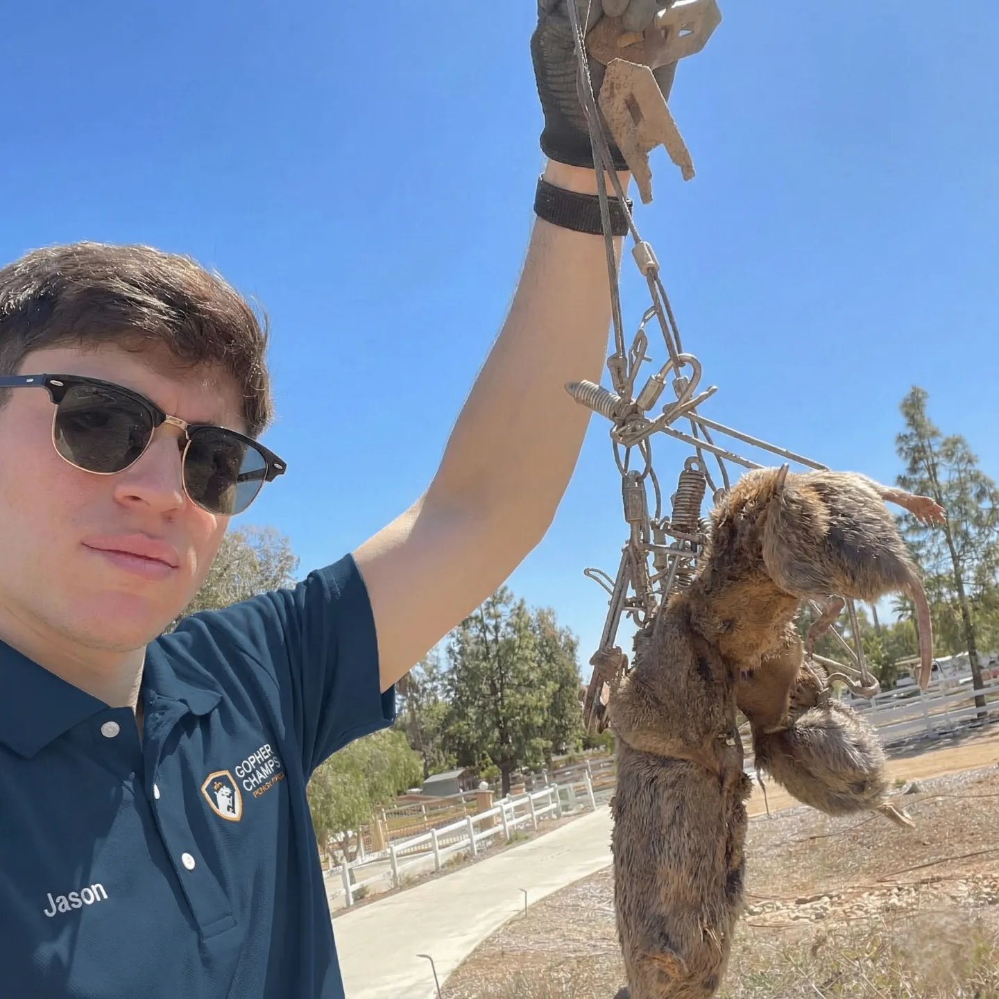 Jason, Gopher Champs technician, holding a successfully trapped gopher